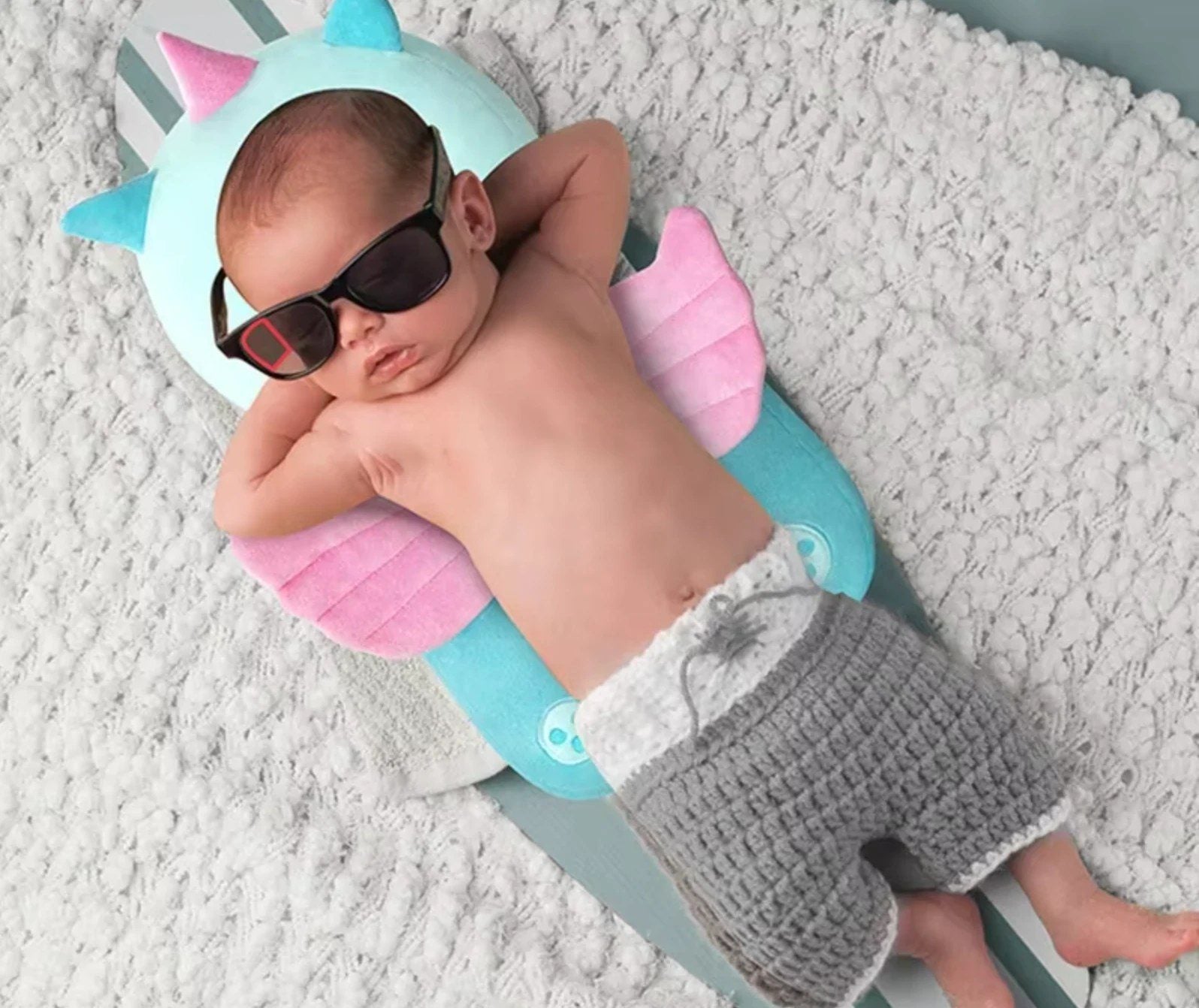 Baby relaxing on their back with the unicorn Backpack